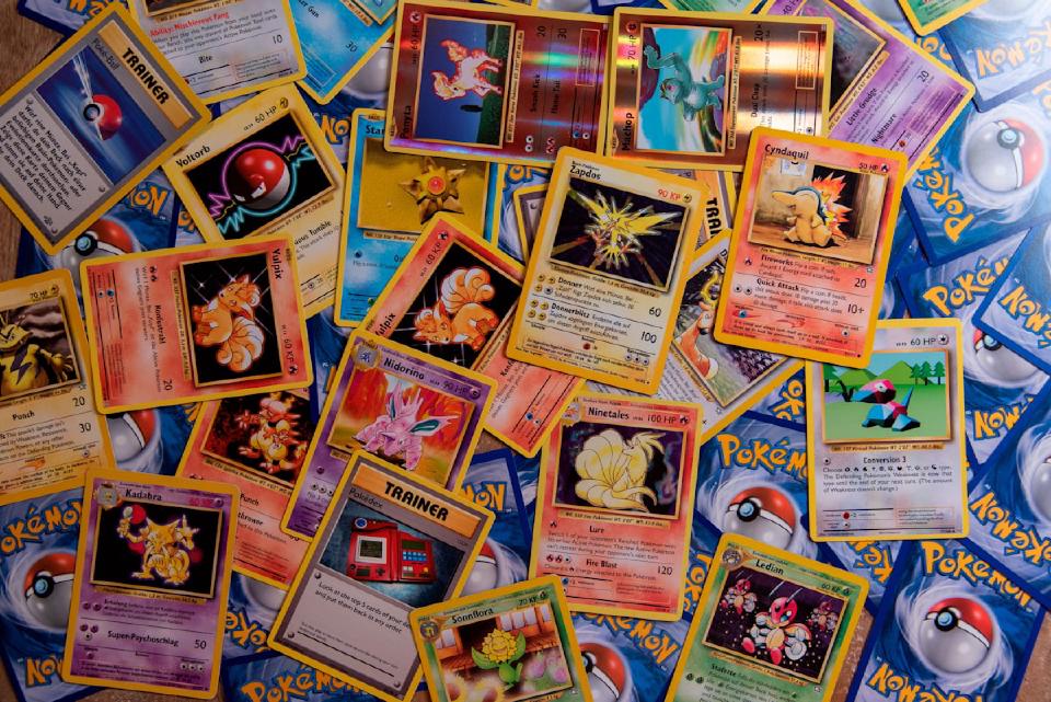Assorted Pokemon cards spread out for collector market analysis